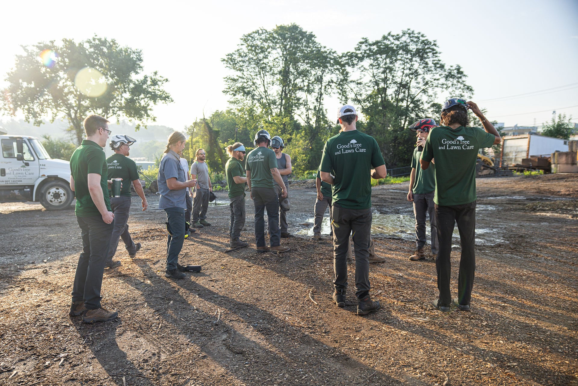 tree techs and lawn crew meeting in the yard